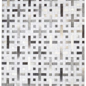 May include: A rectangular rug with a woven pattern. The rug features a repeating design of alternating light and dark gray rectangular shapes against a white background. The rug's texture appears to be soft and inviting.