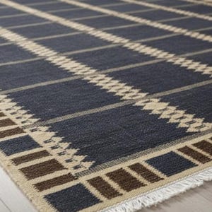 May include: A navy blue and beige area rug with a geometric plaid pattern. The rug features a repeating design of dark blue squares and beige diagonal lines, with a fringe border. The rug is made of a woven material.