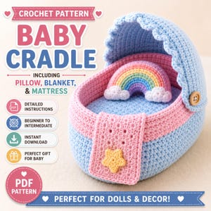 May include: A crochet pattern for a baby cradle, including a pillow, blanket, and mattress. The cradle is light blue and pink with a small yellow star accent. Inside, a rainbow-shaped pillow sits on a light blue mattress. Text includes CROCHET PATTERN BABY CRADLE, INCLUDING PILLOW, BLANKET, & MATTRESS, and PERFECT FOR DOLLS & DECOR!