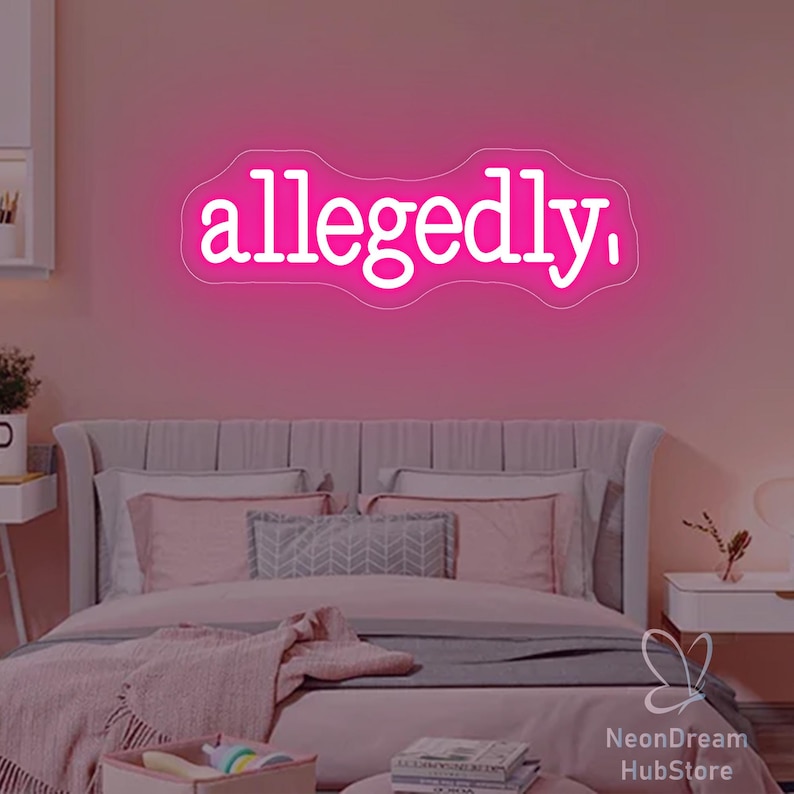 May include: A neon sign in white script reads "allegedly," against a pink wall. The sign is above a bed with pink bedding and pillows. The room has a modern, minimalist aesthetic.