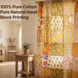 May include: A patterned curtain featuring a patchwork design with floral motifs in yellow, orange, and pink. The text on the wall reads "100% Pure Cotton Pure Natural Hand Block Printing."
