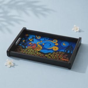 May include: A rectangular black wooden serving tray featuring a vibrant, detailed illustration of a peacock with colorful plumage against a swirling blue night sky, a crescent moon, and a dark architectural silhouette on the interior base.