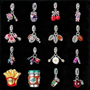 May include: A collection of silver-toned charm pendants with colorful enamel details. Designs include a cupcake, cherries, flowers, a mushroom, coffee cup, french fries, and other food-themed and decorative charms.
