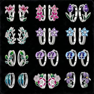 May include: A selection of silver hoop earrings with floral designs. The earrings showcase colourful enamel and gemstone details, such as pink lilies, purple tulips, and blue flowers. The earrings are presented against a black backdrop.