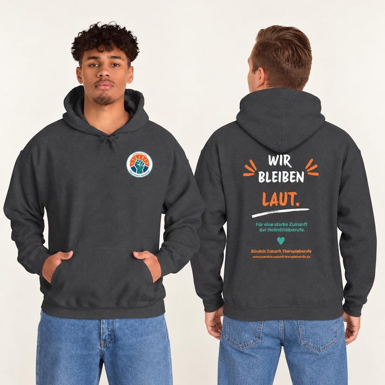 May include: A dark gray hooded sweatshirt featuring a circular logo with a raised fist on the front. The back displays the text WIR BLEIBEN LAUT, F&uuml;r eine starke Zukunft der Heilmittelberufe, and B&uuml;ndnis Zukunft Therapieberufe with a heart icon.