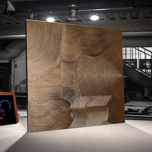 May include: A large, rectangular, bronze-coloured wall panel with a textured, abstract design. The design features a combination of curved lines, circles, and geometric shapes. The panel is displayed in a modern setting, with a polished finish.