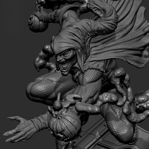 May include: A grayscale sculpture of the Green Goblin, a comic book villain, in a dynamic pose. The figure is detailed with a menacing expression, a hooded cloak, and pumpkin bombs. The sculpture has a textured, scaly appearance.