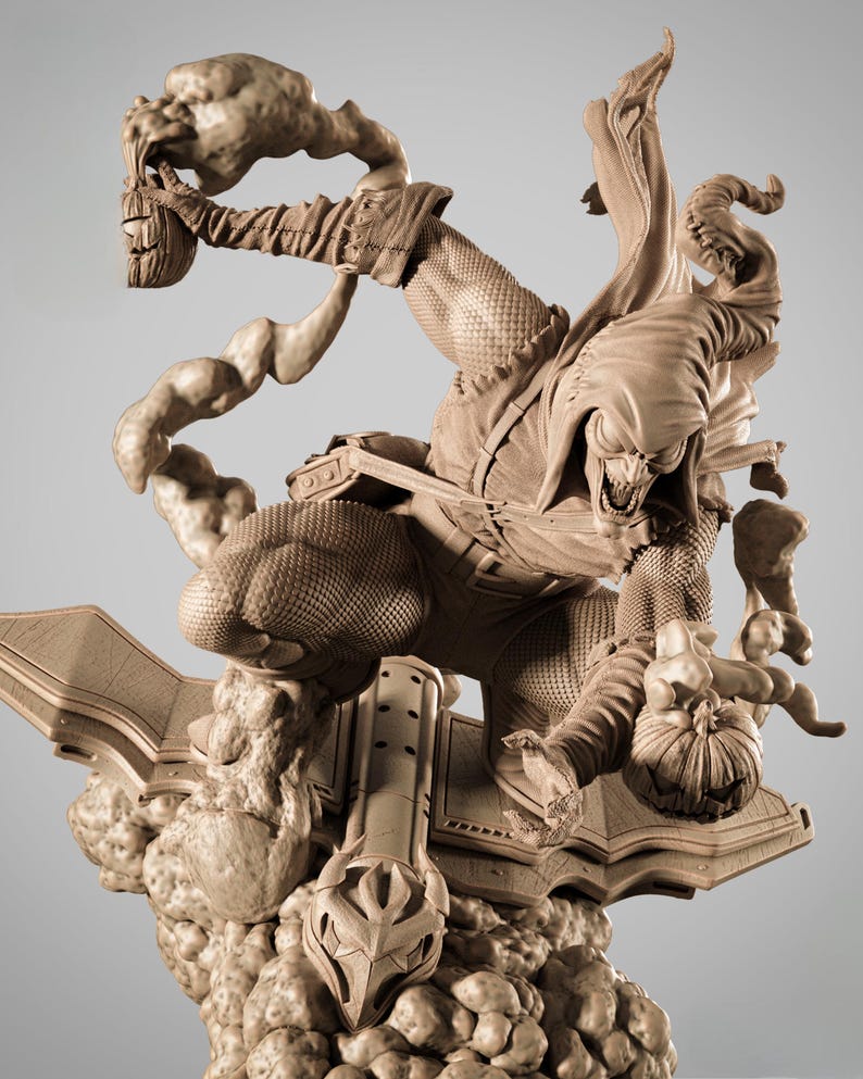 May include: A detailed, tan-colored sculpture of a comic book villain in a dynamic pose. The figure is wearing a hooded costume and holding a pumpkin bomb. The sculpture is mounted on a stylized base with cloud-like elements.