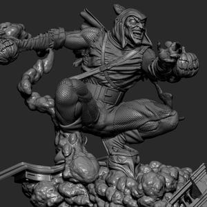 May include: A grayscale sculpture of the Green Goblin, a comic book villain, in a dynamic pose. He is wearing a hooded costume and holding pumpkin bombs. The sculpture is detailed, with textures and a menacing expression.
