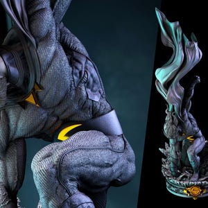 May include: A detailed statue of a muscular figure in a dark grey suit with yellow accents. The figure is kneeling, with a cape flowing behind it. A second statue is visible on the right, with a similar design. The statues are on a dark background.