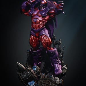 May include: A detailed statue of a muscular figure in a dynamic pose. The figure is predominantly red and purple, with a helmet and armor. The statue is set on a detailed base with debris and a circular emblem. The overall theme is superhero or comic book character.