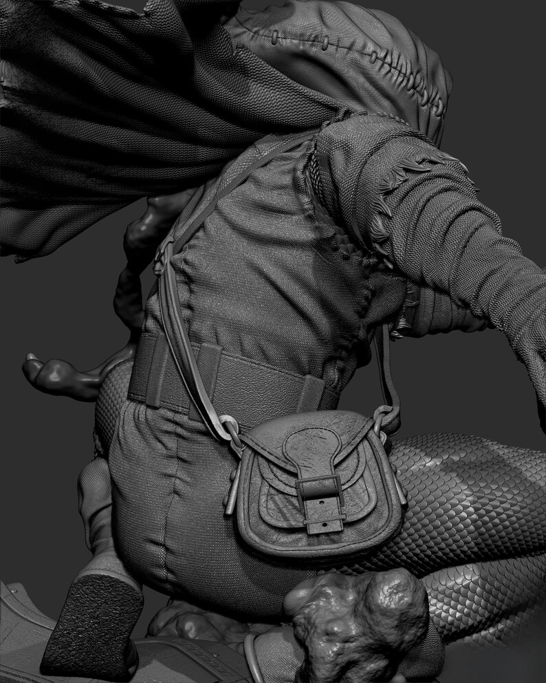 May include: A detailed grayscale sculpture of a fantasy character. The figure wears a hooded cloak, textured clothing, and a small satchel. The design includes intricate stitching and scale-like patterns, suggesting a mythical or medieval theme.