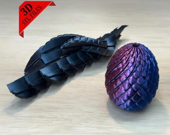 May include: A 3D-printed dragon wing and egg. The wing is black and segmented. The egg is a gradient of purple and blue, with a textured, scaled surface. The image includes a red banner with the text "3D STL FILES".