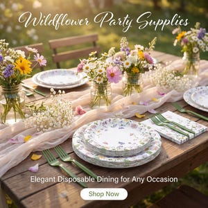 May include: A set of disposable party supplies featuring a wildflower pattern on white plates and napkins, paired with green plastic forks. The table is decorated with glass jars filled with fresh flowers and a light fabric runner.