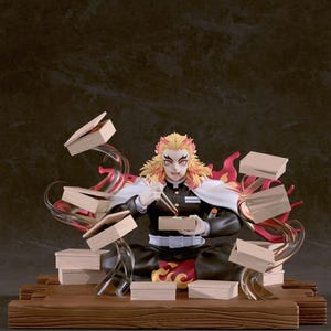 May include: A detailed figurine of a character from the anime series Demon Slayer. The figure is seated, wearing a black uniform with a white cape, and has fiery hair. Books and flames surround the figure, with a wooden base.