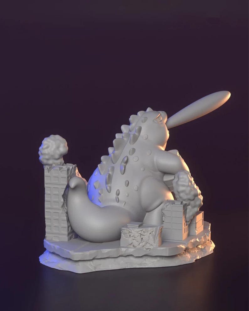 May include: A grey 3D-printed sculpture of a monster with a baseball bat, destroying buildings. The monster has a spiky back and a long, rounded tail. The sculpture is set on a rocky base with detailed building ruins.