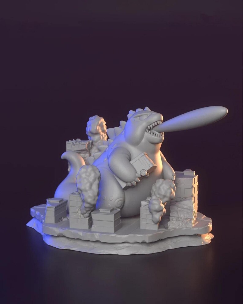 May include: A 3D-printed sculpture of a cartoon monster with a long tongue, destroying a city. The monster is holding a building and is surrounded by stylized buildings and smoke clouds. The sculpture is in a neutral colour.