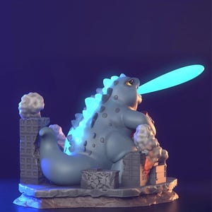 May include: A light blue Godzilla figurine with a glowing blue atomic breath. The figurine is destroying miniature buildings, with smoke and rubble details. The figure has a textured back and is set on a stone base.