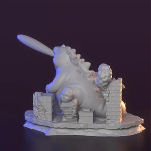 May include: A grey 3D-printed sculpture of a monster destroying a city. The monster has a long tongue and spiky back. Buildings are crumbling, with smoke rising. The sculpture is on a grey base.