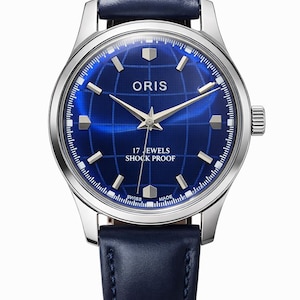 May include: A silver-toned wristwatch with a deep blue face featuring the brand name "ORIS" and the text "17 JEWELS SHOCK PROOF". The watch has a blue leather band and a grid pattern on the watch face.