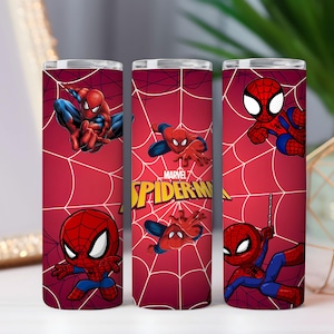 May include: Three red insulated tumblers with Spider-Man designs. Each tumbler displays Spider-Man in various action poses, set against a red webbed backdrop. The Marvel Spider-Man logo is visible on one of the tumblers.