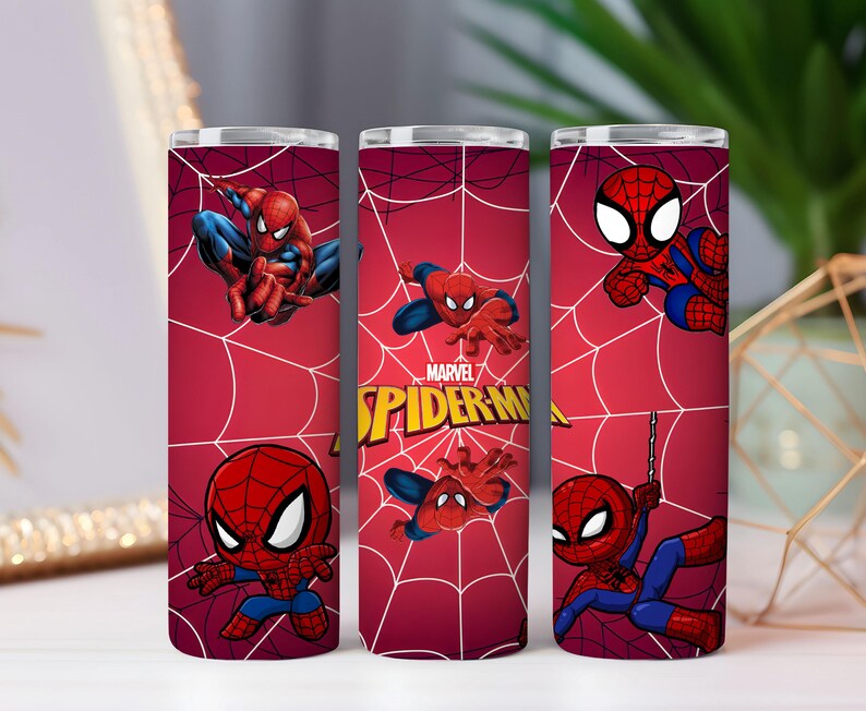 May include: Three red insulated tumblers with Spider-Man designs. Each tumbler displays Spider-Man in various action poses, set against a red webbed backdrop. The Marvel Spider-Man logo is visible on one of the tumblers.