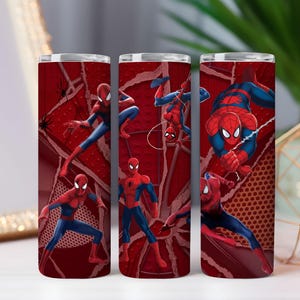 May include: Three red insulated tumblers with Spider-Man illustrations. The design features the superhero in action poses against a red webbed background. The character is shown in his iconic red and blue costume.