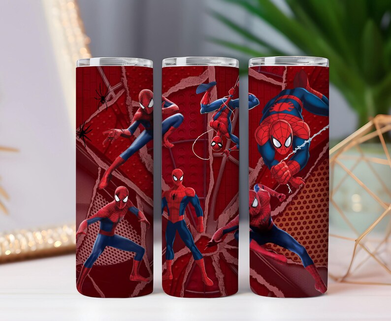 May include: Three red insulated tumblers with Spider-Man illustrations. The design features the superhero in action poses against a red webbed background. The character is shown in his iconic red and blue costume.
