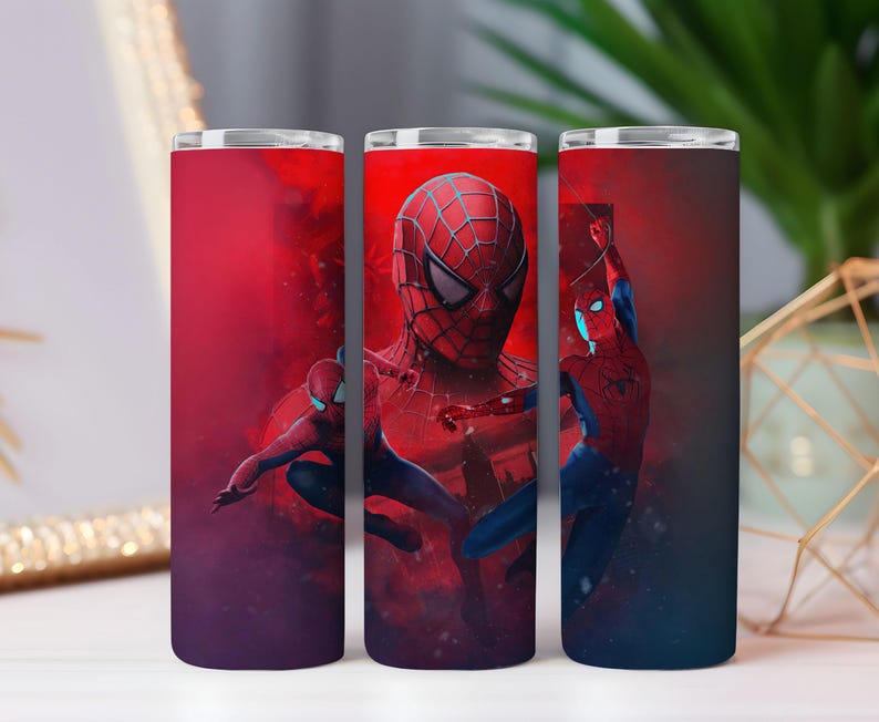 May include: Three stainless steel tumblers with a Spider-Man design. The tumblers feature a red and blue colour scheme with images of Spider-Man in action. The background is a gradient of red and purple.