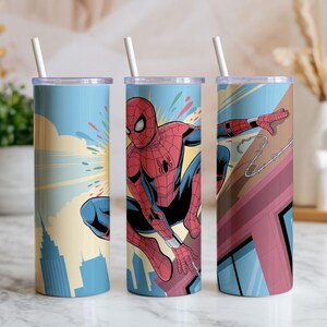 May include: Three stainless steel tumblers with Spiderman graphics. Each tumbler features a different Spiderman design, with a blue background and a white straw. The designs include Spiderman in action, cityscapes, and web-slinging.