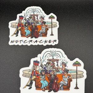 May include: Two stickers featuring a cartoon illustration of characters from The Nutcracker ballet. The characters are seated on a brown couch in front of a fountain. The text "N.U.T.C.R.A.C.K.E.R" is printed at the bottom of each sticker.