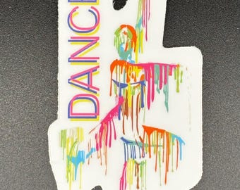 May include: A white sticker with the word "DANCE" in rainbow colors. The sticker features a colorful illustration of a person with paint dripping down. The design is vibrant and eye-catching, perfect for dance enthusiasts.