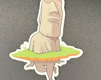 May include: A sticker featuring a cartoon illustration of a Moai statue. The statue is depicted from the chest up, with legs and feet in ballet shoes. The statue is standing on a patch of green grass.
