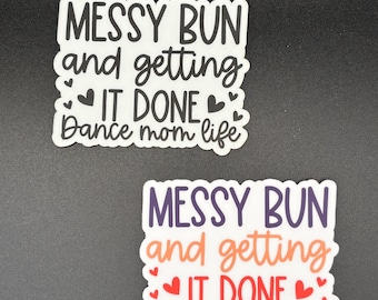 May include: Two white stickers with the text "MESSY BUN and getting IT DONE Dance mom life". One sticker has black text, the other has purple, orange, and red text. Both stickers have a white border and heart accents.