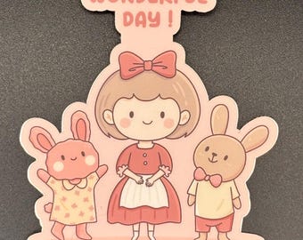 May include: A sticker featuring a cartoon illustration of a girl and two bunnies. The girl wears a red dress and apron, with a bow in her hair. The bunnies are dressed in outfits. The text "WONDERFUL DAY!" is above the girl.