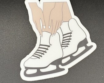 May include: A sticker featuring a pair of white ice skates with black blades and laces. The illustration includes hands tying the laces. The sticker has a white border and is set against a dark background.