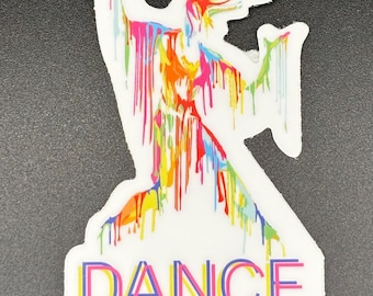 May include: White sticker with a colorful abstract design of a figure with paint drips. The word "DANCE" is written in a layered, colorful font at the bottom of the sticker.