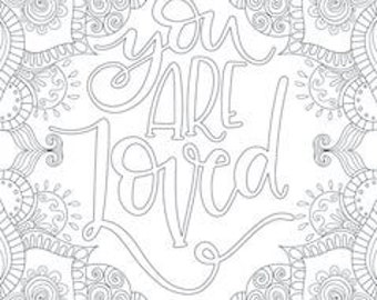 May include: Black and white line art coloring page with the words "You Are Loved" in cursive script. The text is surrounded by a detailed floral and geometric border, ready for coloring.