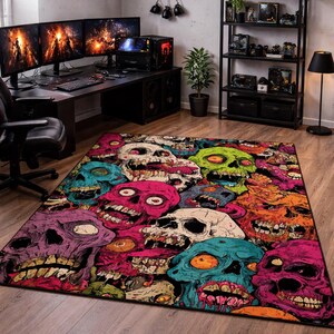 May include: A colorful area rug featuring a repeating pattern of stylized, grinning skulls in shades of pink, green, blue, orange, and purple. The rug is rectangular and appears to be made of a soft, woven material.