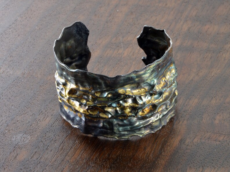 Artistic fold-formed hammered silver-and-gold cuff bracelet.