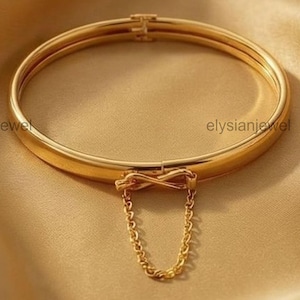 May include: A white ceramic mug with a black handle and the text "But First, Coffee" in a black, handwritten-style font. The mug is on a white surface.