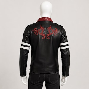 May include: Black leather jacket with a red collar and embroidered red design on the back. Features white stripes on the sleeves and a zip closure. A stylish outerwear piece.