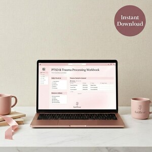 May include: A rose gold laptop displays a "PTSD & Trauma Processing Workbook" with a pink interface. Two pink mugs and a stack of books are on the white surface. The words "Instant Download" are in a pink circle in the background.