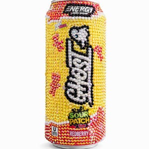 May include: A bedazzled Ghost Energy drink can in a yellow and red color scheme. The can features the text "Ghost" in white with a black outline, and "Sour Patch Kids Redberry" branding. The can is covered in small, sparkling gems.