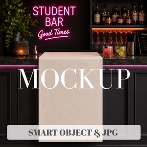 May include: A rectangular, light beige fabric runner draped over a dark bar counter. The word MOCKUP is printed in large white letters across the center, with SMART OBJECT & JPG text displayed in a white rectangular banner at the bottom.