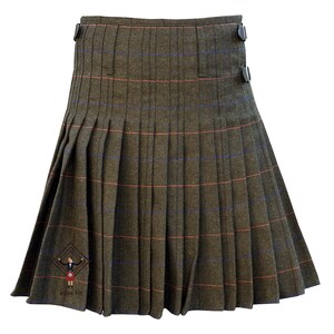 May include: A pleated kilt in a green and brown plaid pattern with orange and blue accents. The kilt has a button closure on the side and a logo near the hem. This traditional garment is made of a woven fabric.