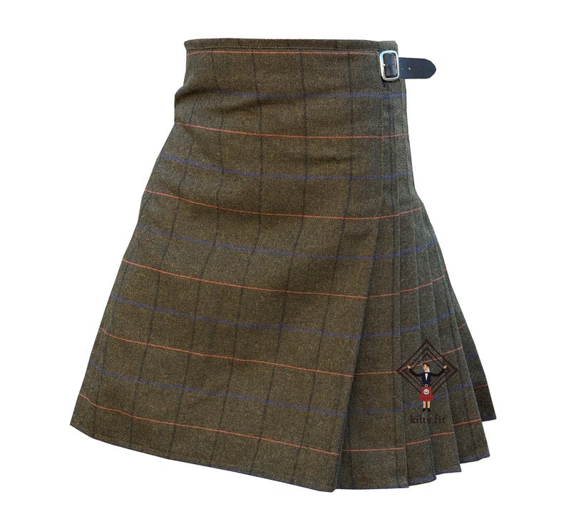 May include: A brown kilt with a plaid pattern featuring orange and blue lines. The kilt has a wrap-around design with a leather strap and buckle closure. The garment is made of a textured fabric.
