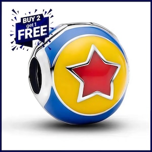 May include: A spherical charm bead featuring a yellow circular center with a red star, surrounded by a blue border and silver metal edges. The charm includes a dark blue graphic overlay in the upper left corner with the text BUY 2 get 1 FREE.