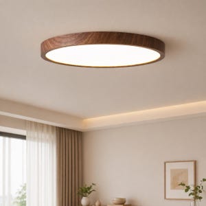 May include: A round, flush-mount ceiling light fixture with a dark wood grain finish. The light has a bright, white, circular LED panel. The fixture is mounted on a white ceiling in a room with neutral-colored walls and curtains.