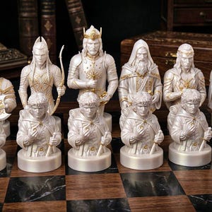 A split-screen promotional banner for a Mythic Fantasy Chess Set STL collection. The top shows a row of finely crafted, white and gold character busts (Light faction: King, elves, dwarf). The bottom shows a row of dark, menacing, and intricate character busts (Dark faction: armored figures, ghouls). The center features a gothic-style title banner that reads: 'MYTHIC FANTASY CHESS SET STL'. The background shows a library and a dark fortress.